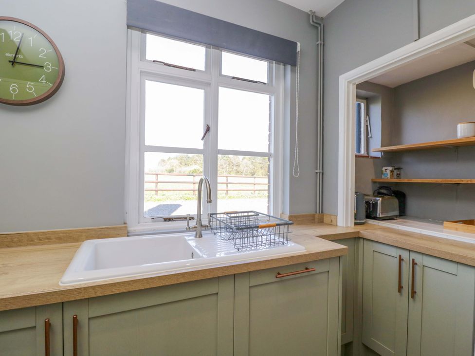 A kitchen with a sink and window at 3 Woods Farm House in Chippenham