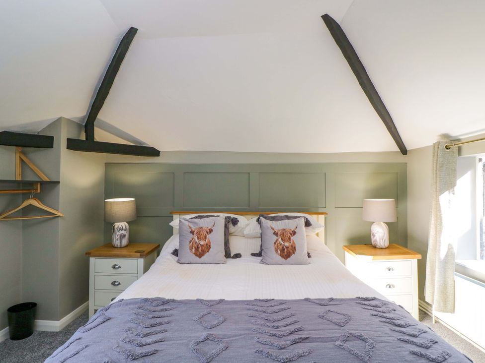 A bedroom with a bed and side tables at 3 Woods Farm House Chippenham