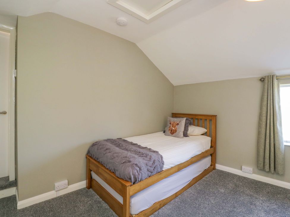 A bedroom with a bed and window at 3 Woods Farm House in Chippenham