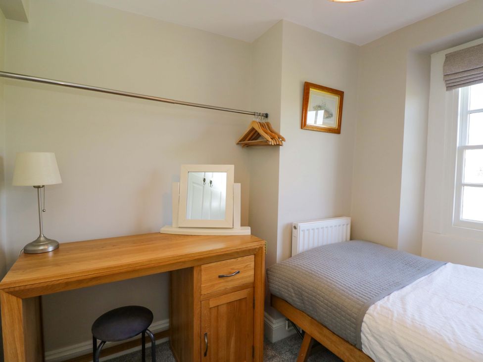 A bedroom with a bed and desk at 3 Woods Farm House in Chippenham