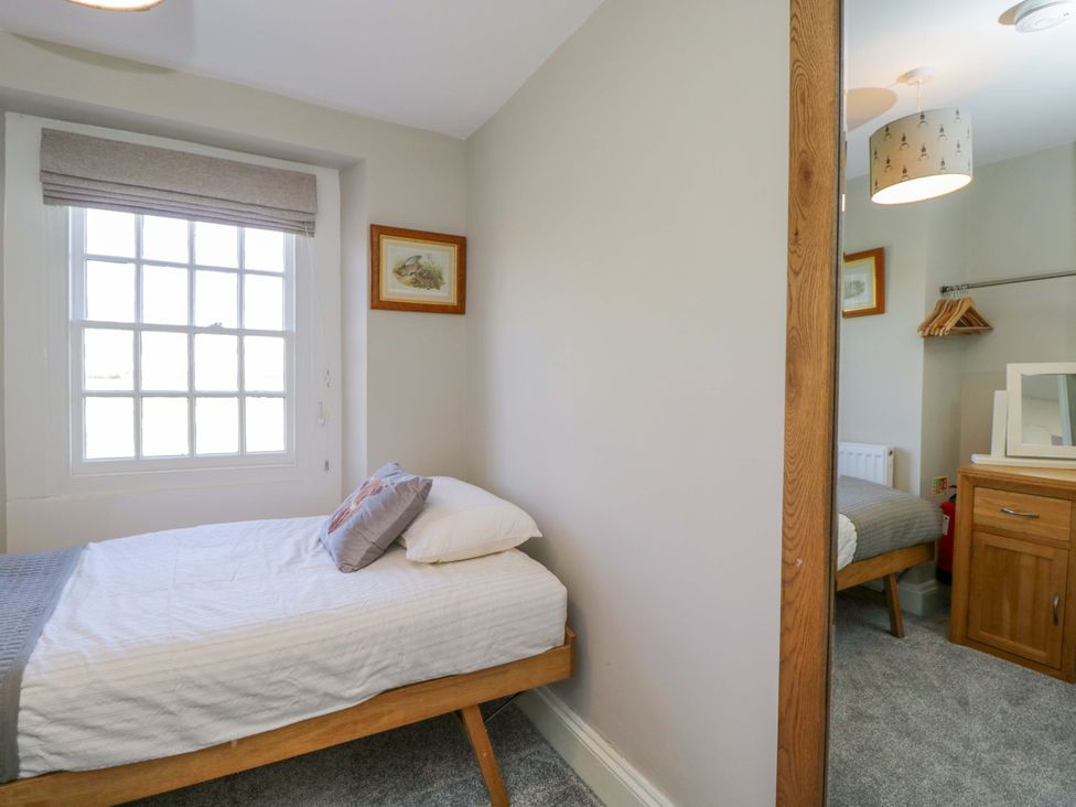 A bedroom with a bed, window, and dresser at 3 Woods Farm House in Chippenham