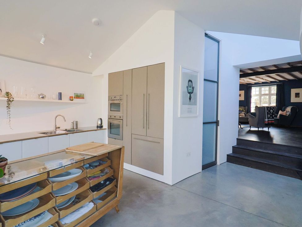 A kitchen with a sink and cabinets at Bredy Cottages in Burton Bradstock