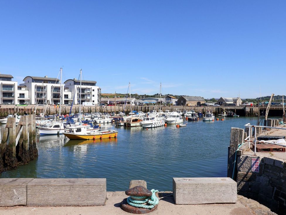 A harbor with boats at Bredy Cottages in Burton Bradstock