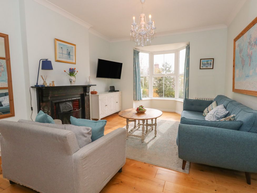 A living room with a sofa, coffee table and TV at Millmead House Portesham