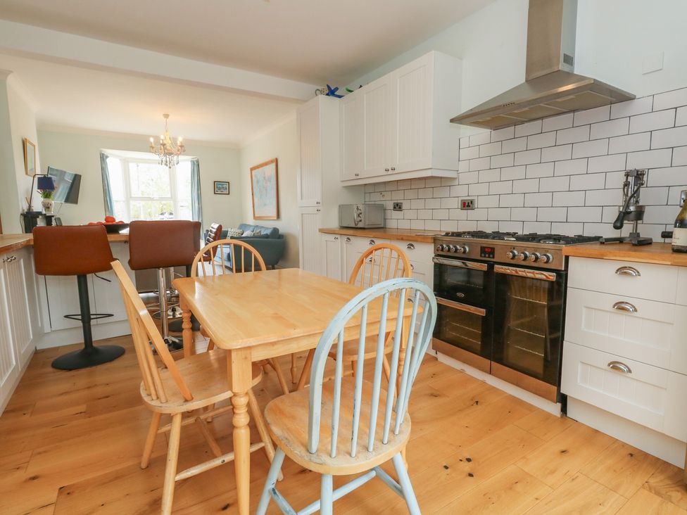 A kitchen with a dining table and chairs at Millmead House Portesham