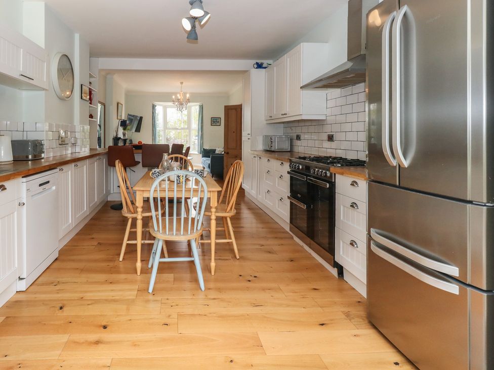 A kitchen with a dining table and chairs at Millmead House Portesham