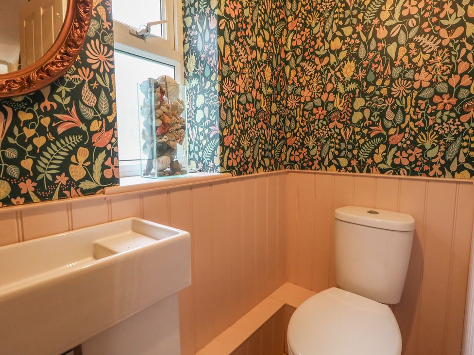 A bathroom with a toilet and sink at Millmead House in Portesham