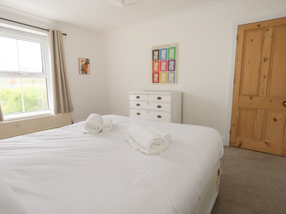 A bedroom with a bed and dresser at Millmead House Portesham
