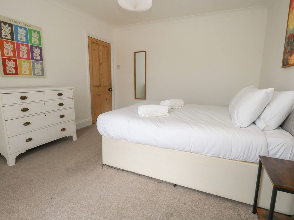A bedroom with a bed and a drawer unit at Millmead House Portesham
