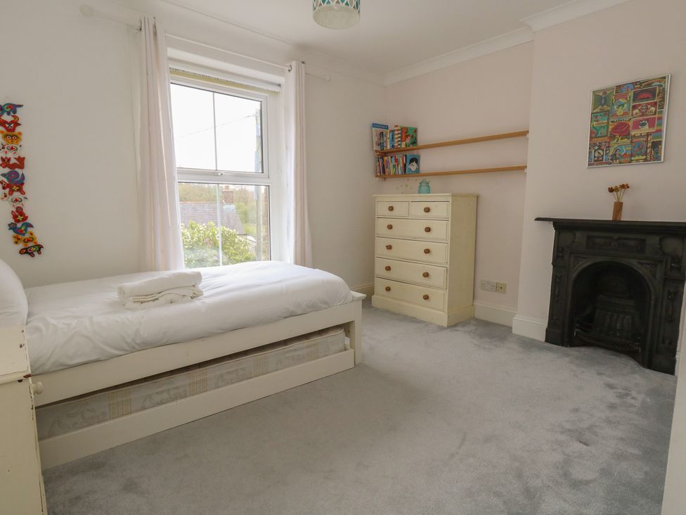 A bedroom with a bed and bookshelf at Millmead House in Portesham