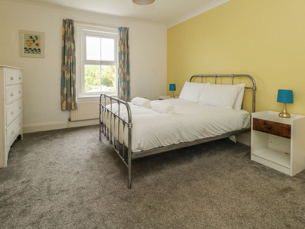 A bedroom with a bed and dresser at Millmead House Portesham