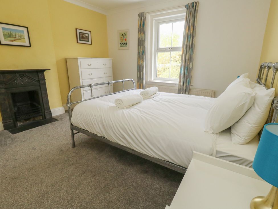 A bedroom with a bed and dresser at Millmead House Portesham