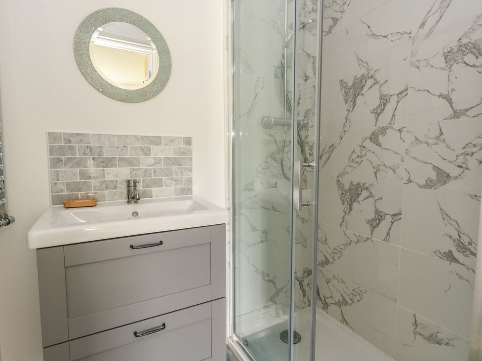 A bathroom with a sink and shower at Millmead House Portesham