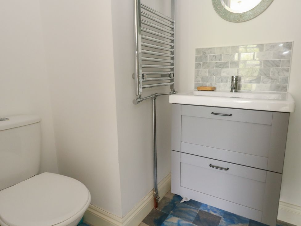 A bathroom with a toilet and sink at Millmead House in Portesham