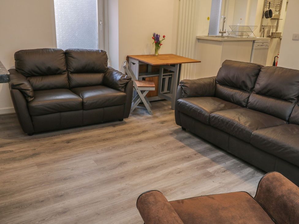 A living room with two sofas and a table at 47A Baxtergate in Whitby