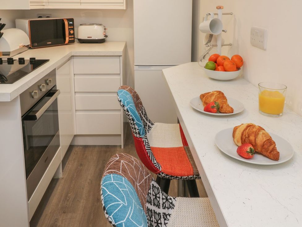 A kitchen with croissants and juice on the countertop at 47A Baxtergate in Whitby
