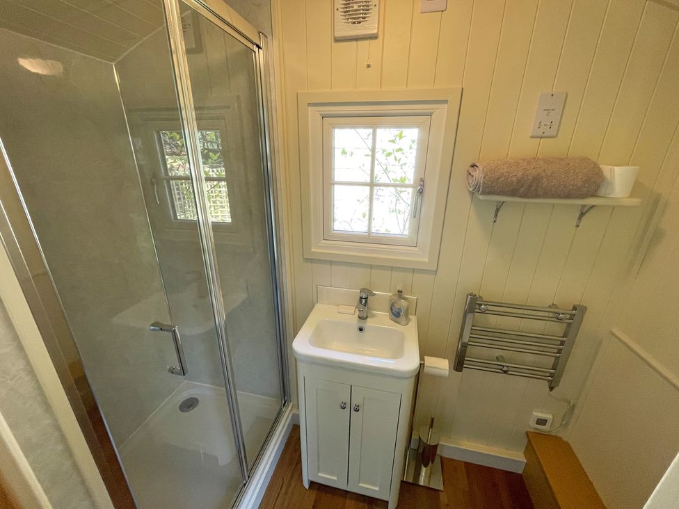 A bathroom with a shower and sink at The Shephards Hut 