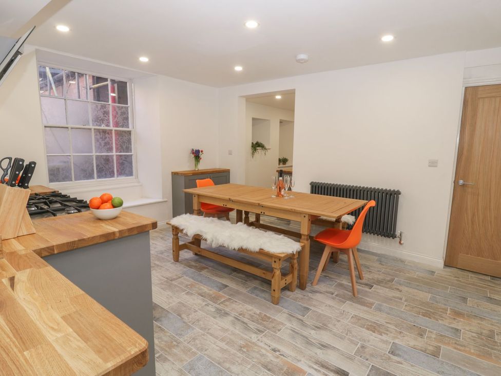 A kitchen with a dining area and gas stove at 47 Baxtergate, Whitby