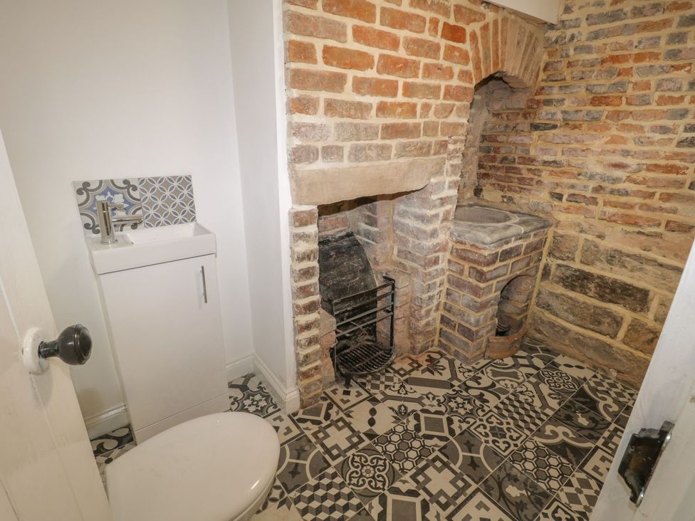 A bathroom with a toilet and sink at 47 Baxtergate in Whitby