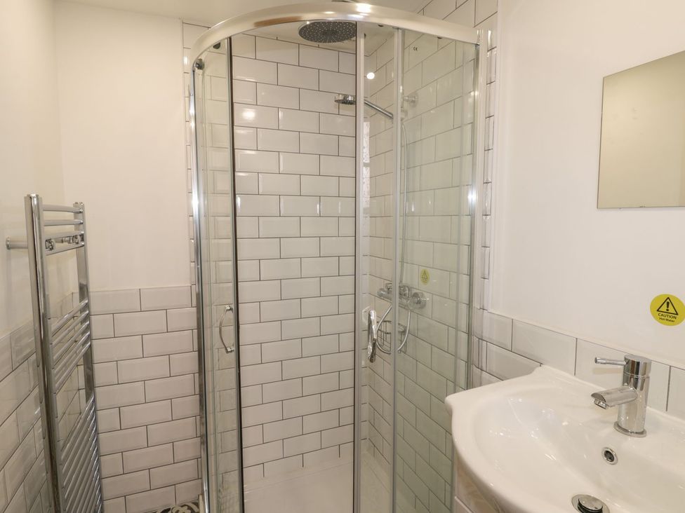 A bathroom with a shower and wash basin at 47 Baxtergate in Whitby