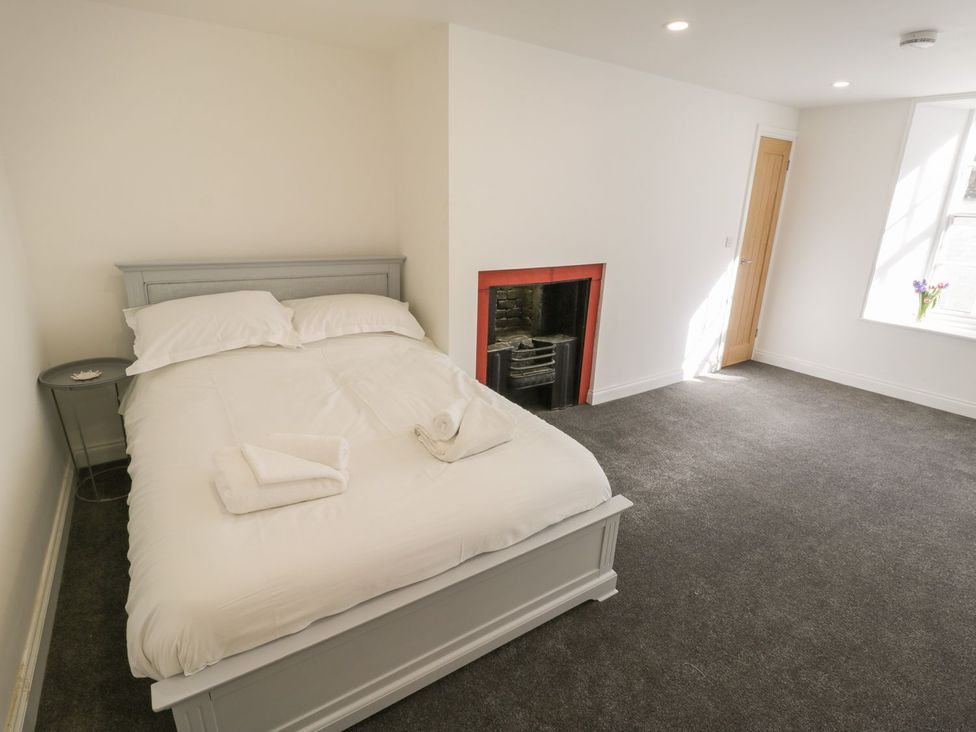 A bedroom with a bed and bedside table at 47 Baxtergate in Whitby