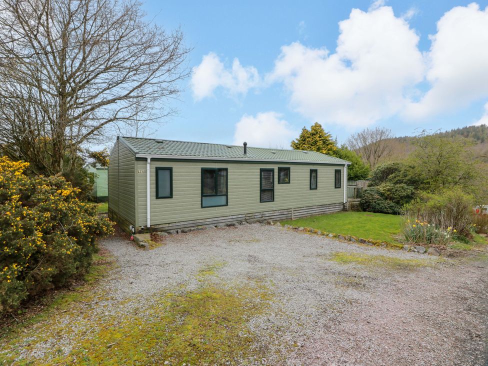 A mobile home with a gravel driveway at L21 Coastal Kippford Kippford near Sandyhills