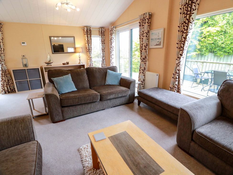 A living room with a sofa and coffee table at L21 Coastal Kippford in Kippford near Sandyhills
