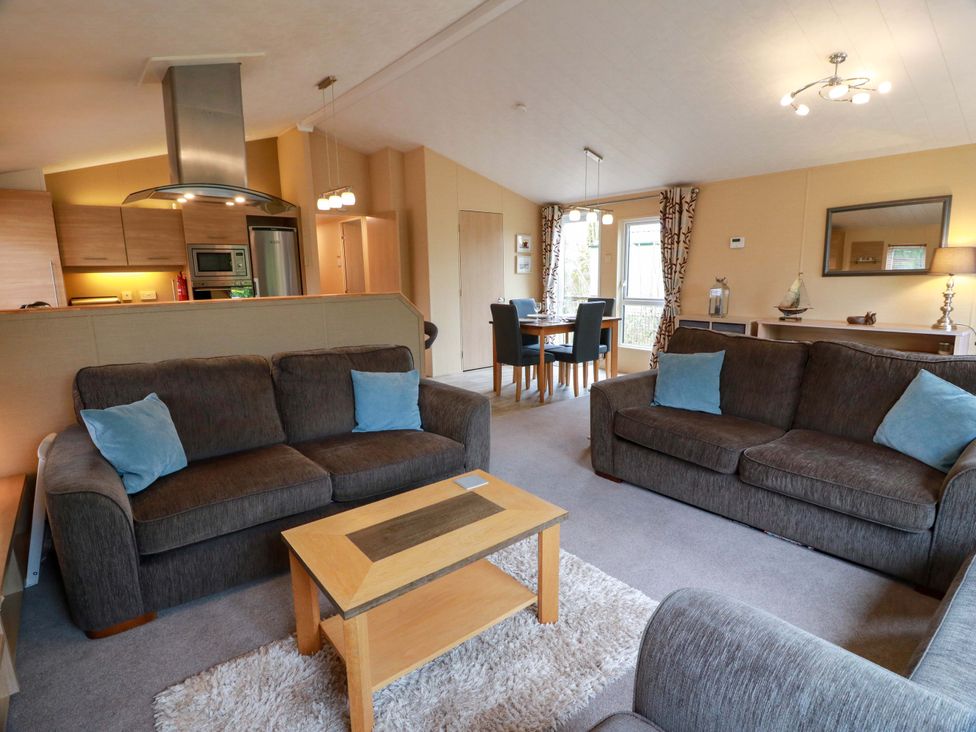 A living room with sofas and a dining area at L21 Coastal Kippford Kippford near Sandyhills