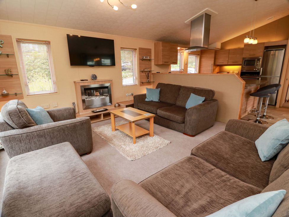 A living room with a television and coffee table at L21 Coastal Kippford Kippford near Sandyhills