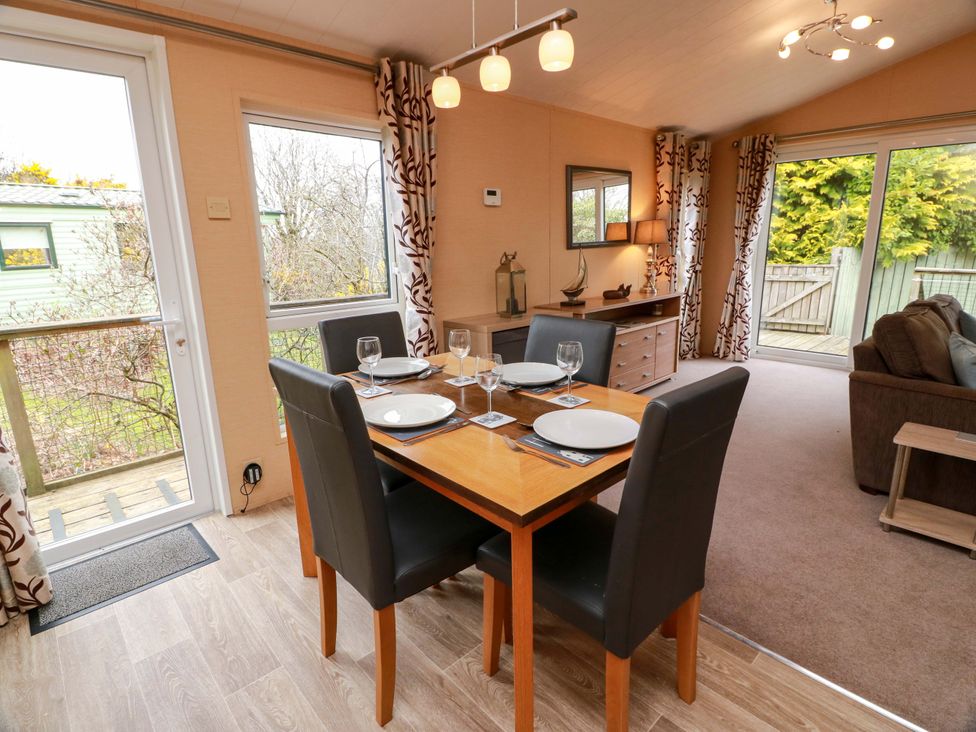 A dining room with a table and chairs at L21 Coastal Kippford near Kippford