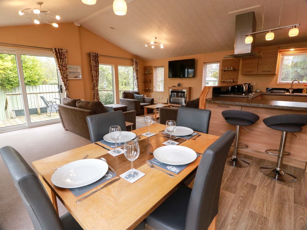 A living room with a dining area and kitchen features at L21 Coastal Kippford Kippford near Sandyhills