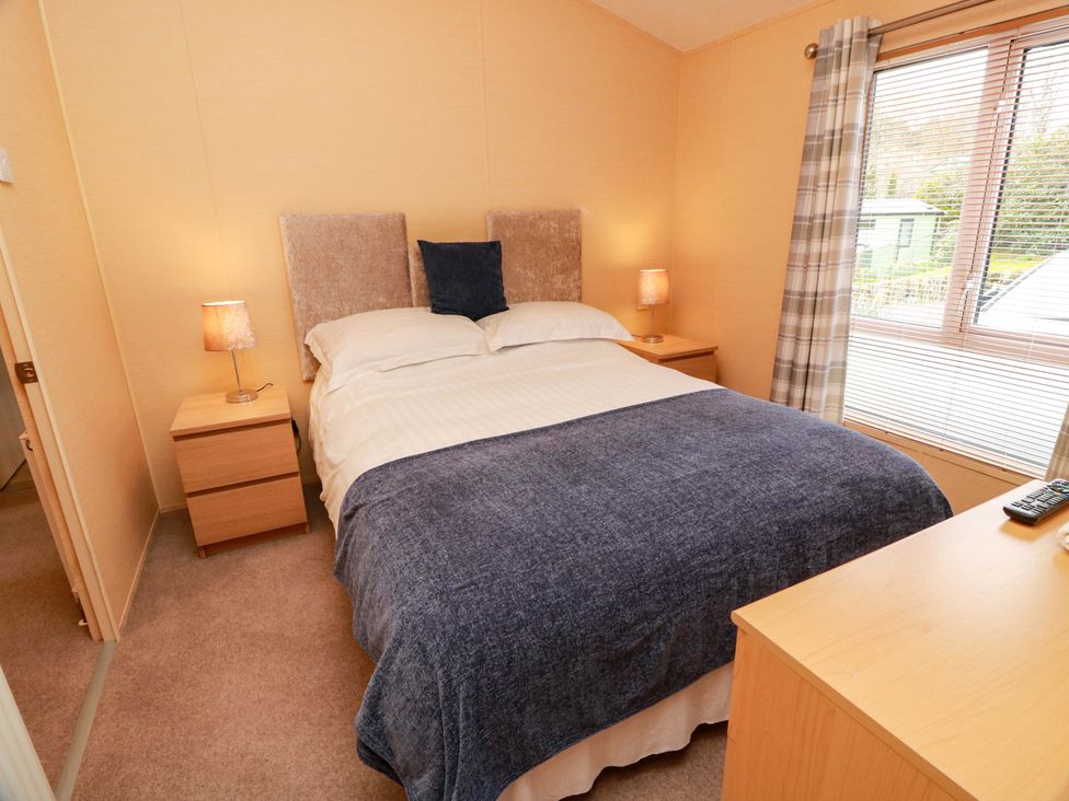 A bedroom with a bed and nightstands at L21 Coastal Kippford Kippford near Sandyhills