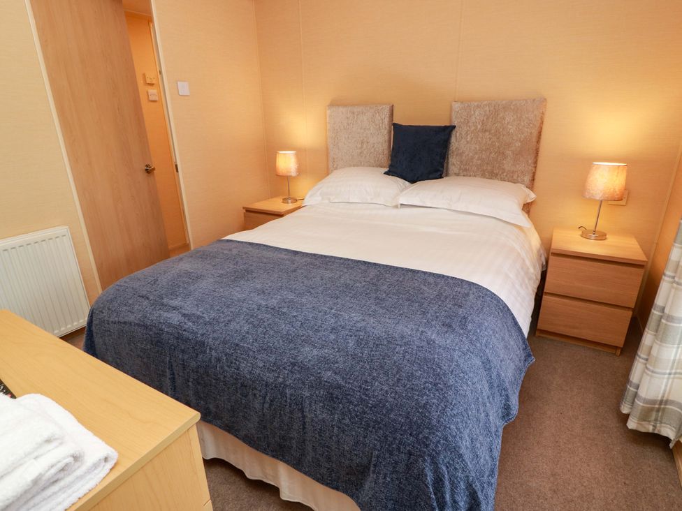 A bedroom with a bed and bedside table at L21 Coastal Kippford in Kippford near Sandyhills