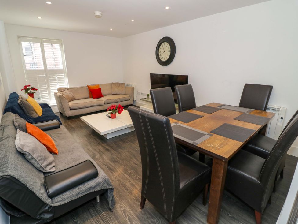 A living room with sofas and a dining table at Apartment 15 in Birmingham