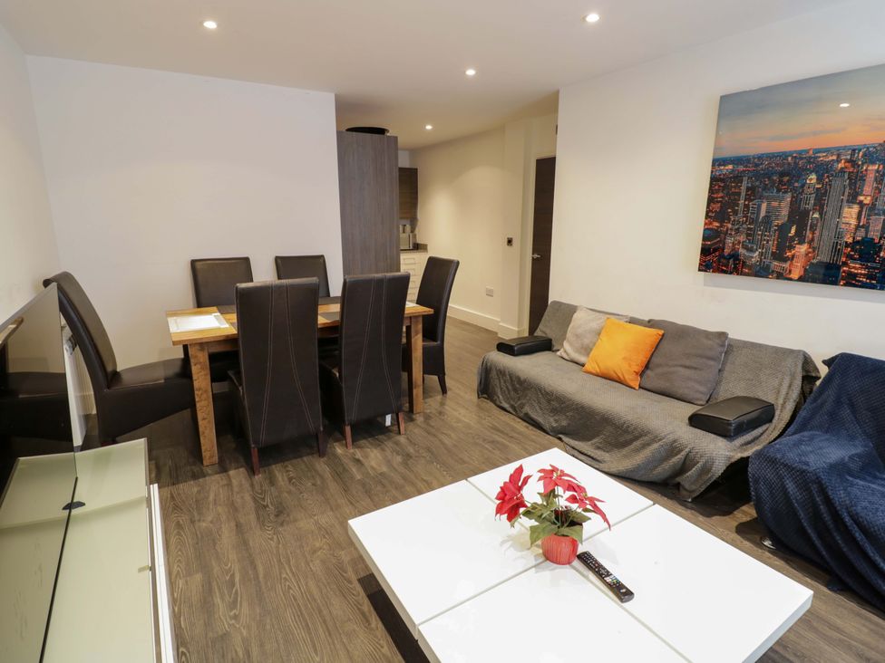 A living room with a dining table and sofa at Apartment 15 in Birmingham