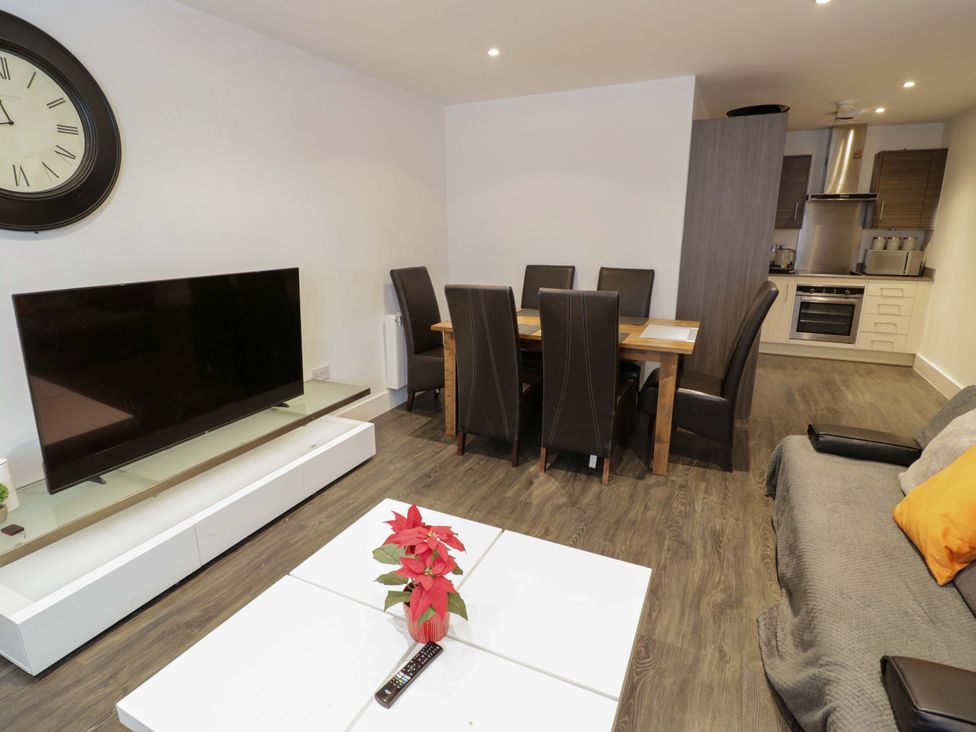 A living room with a television and dining table at Apartment 15 in Birmingham