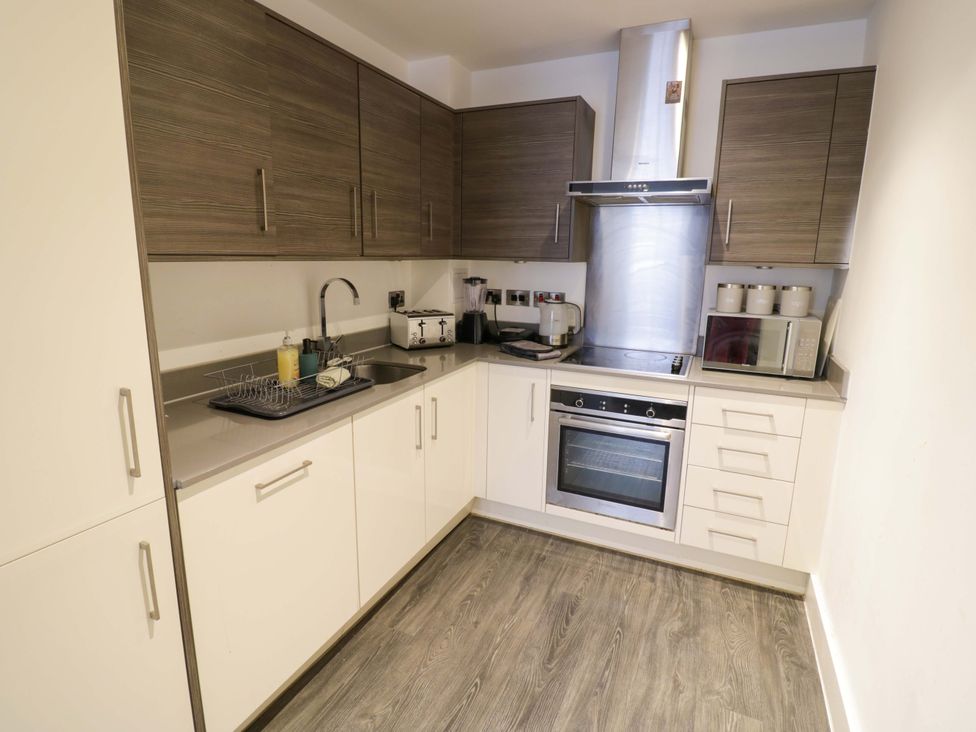 A kitchen with cabinets and appliances at Apartment 15 in Birmingham