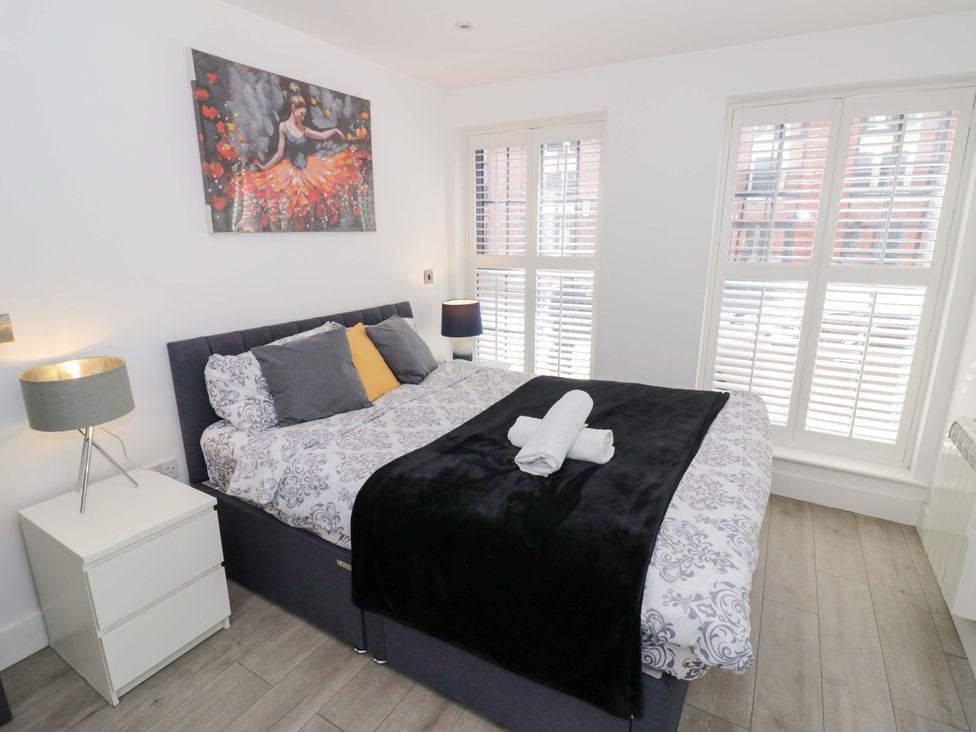 A bedroom with a bed and lamp at Apartment 15 in Birmingham