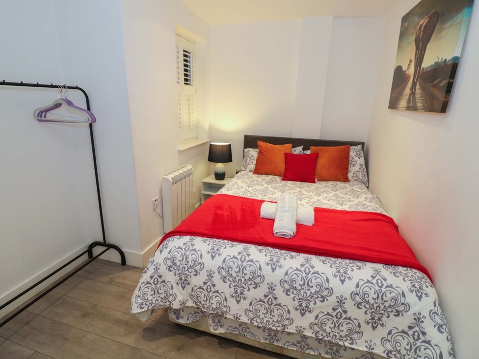 A bedroom with a bed and lamp at Apartment 15 in Birmingham