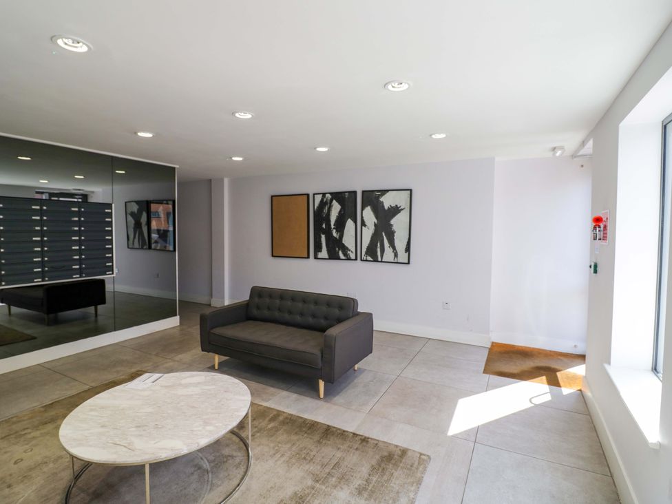 A lobby with a sofa and coffee table at Apartment 15 in Birmingham