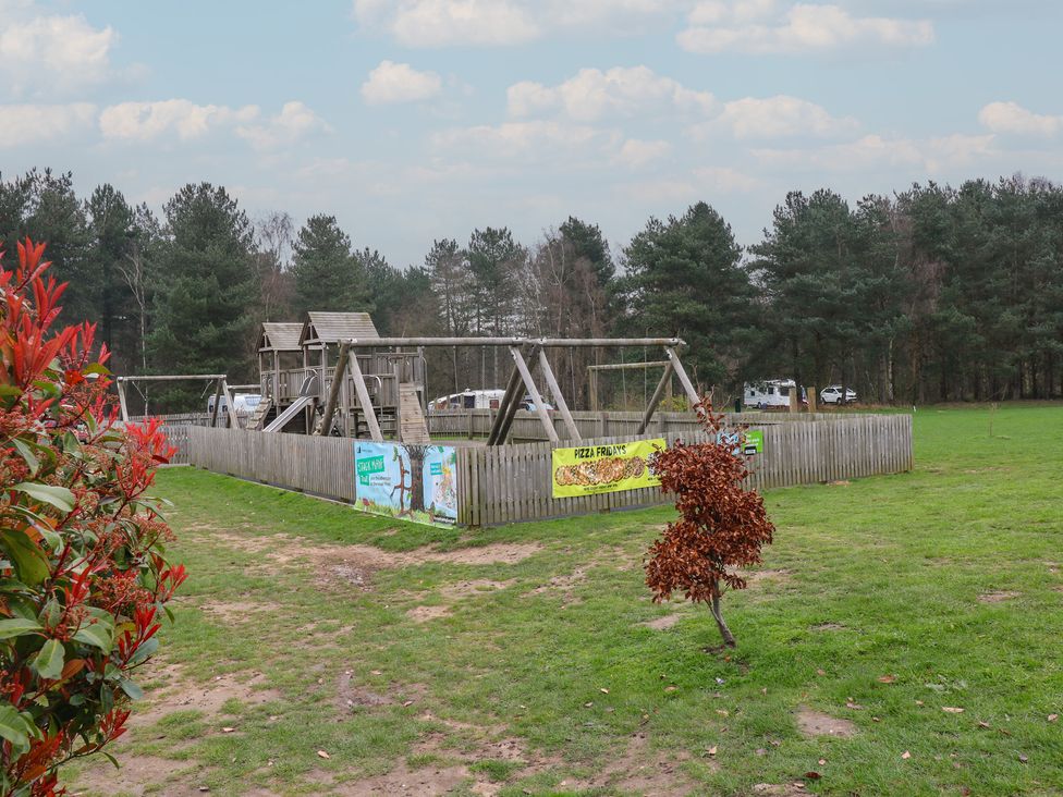 A playground with swings and climbing frame at Sherwood - Family Pod 1 in Mansfield