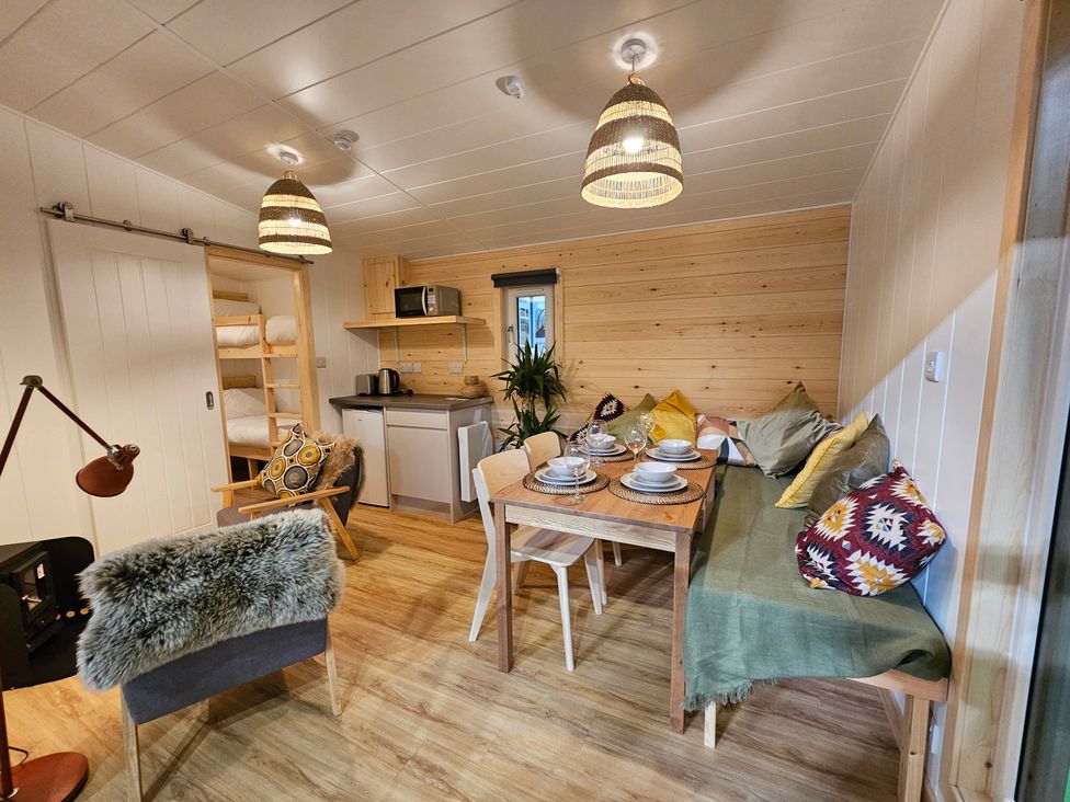A living room with a dining table and kitchen area at Sherwood - Family Pod 1 in Mansfield