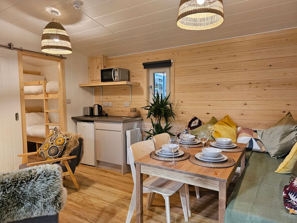 A living room with a table and chairs at Sherwood - Family Pod 1 in Mansfield