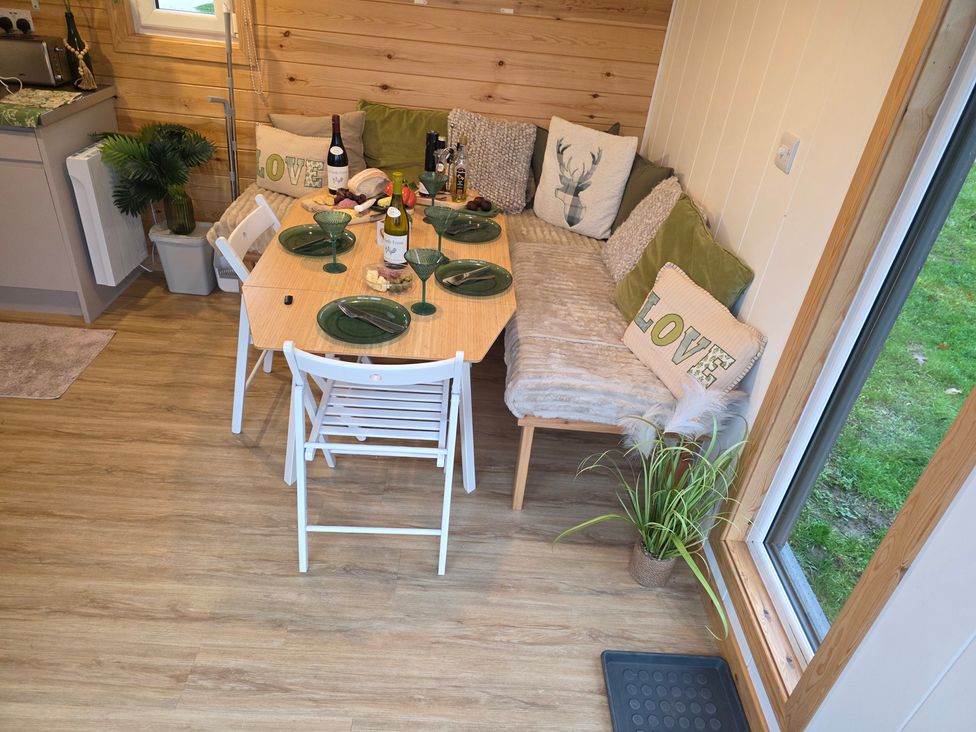 A dining area with a table set for dinner at Sherwood - Family Pod 1, Mansfield