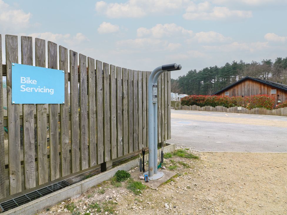 Bike servicing area with a sign and equipment at Sherwood - Family Pod 2 Mansfield