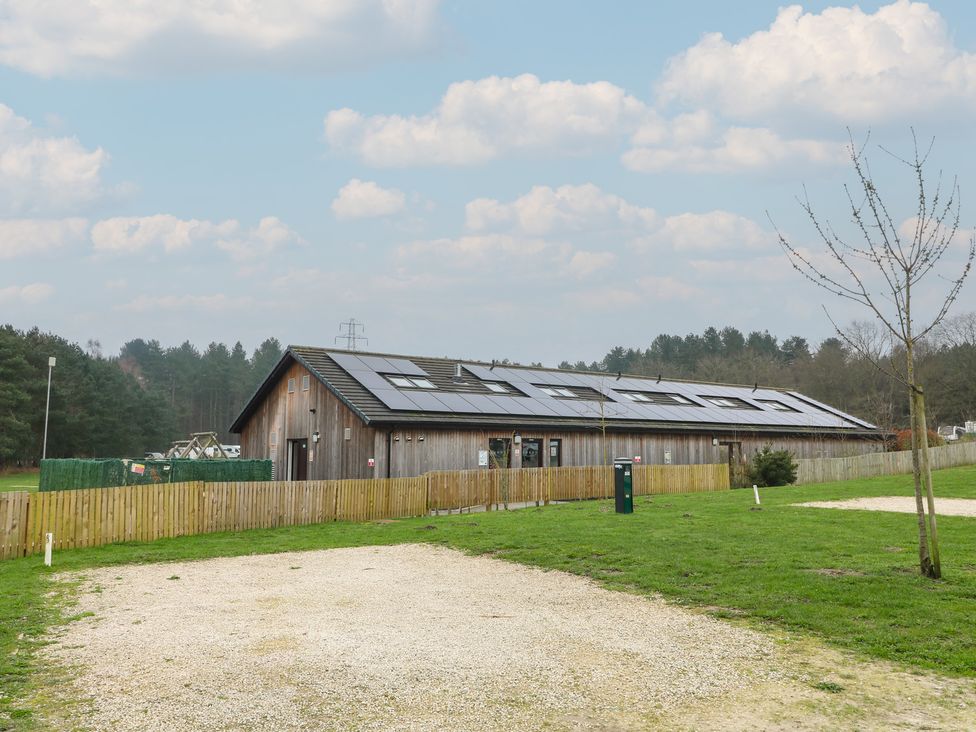 A building with solar panels and a parking area at Sherwood - Family Pod 3 Mansfield