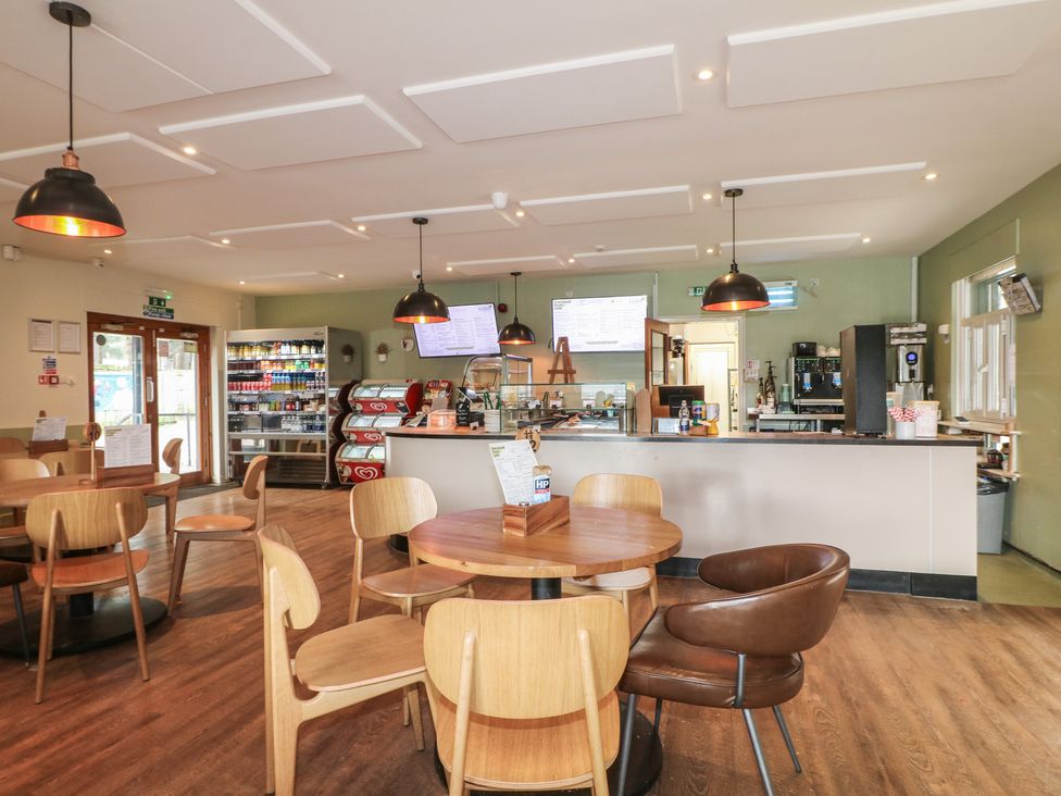 A cafe with tables and a counter at Sherwood - Family Pod 3 in Mansfield