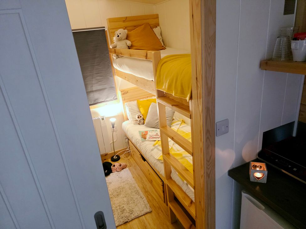 A bedroom with a bunk bed and furniture at Sherwood - Family Pod 3 in Mansfield