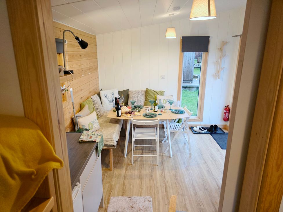 A dining room with a table set for a meal at Sherwood - Family Pod 4 in Mansfield