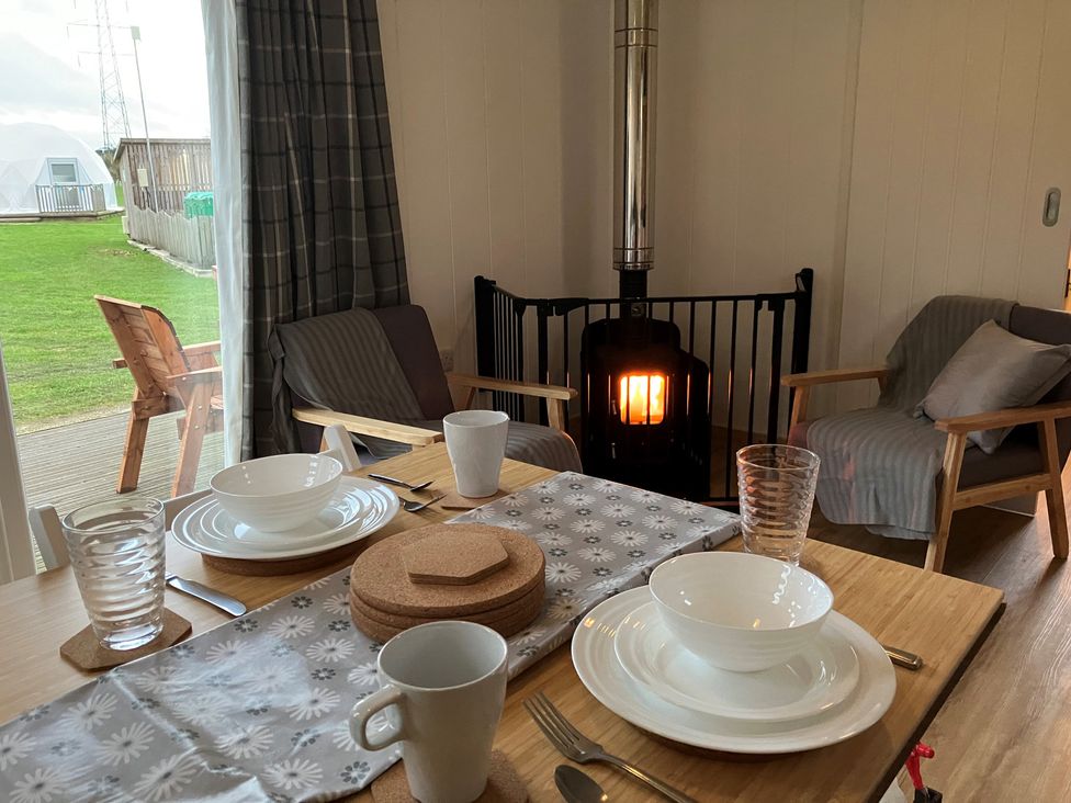 A dining room with a table set at Sherwood - Family Pod 5 in Mansfield